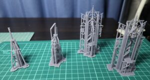 ABS-like resin printed fore and aft masts for a 1/150 IJN destroyer Yukikaze, shown with supports before cleanup