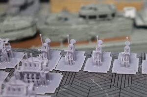 ABS-like resin build plate showing multiple 1/150 Yukikaze 25mm anti-aircraft gun prints with supports for batch production