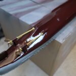 1/150 IJN destroyer Yukikaze RC hull after glossy clear coat application, showing a smooth water-resistant finish around the stern and propeller shafts