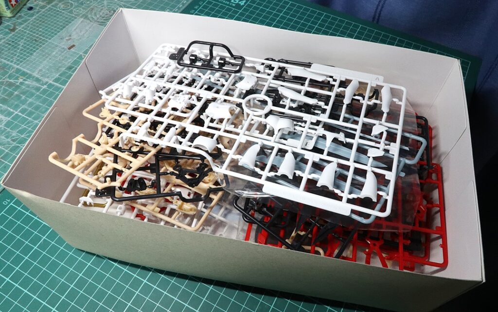 plastic model runners mixed together in a box without organization