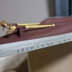 Close-up of a 1/150 IJN destroyer Yukikaze RC hull showing twin propeller shafts, propellers, and rudder area during drivetrain setup (shaft, stern tube, and steering linkage prep)