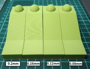 Comparison of FDM layer heights 0.20mm, 0.16mm, 0.12mm, and 0.08mm showing differences in surface finish on a sloped test piece with a dome