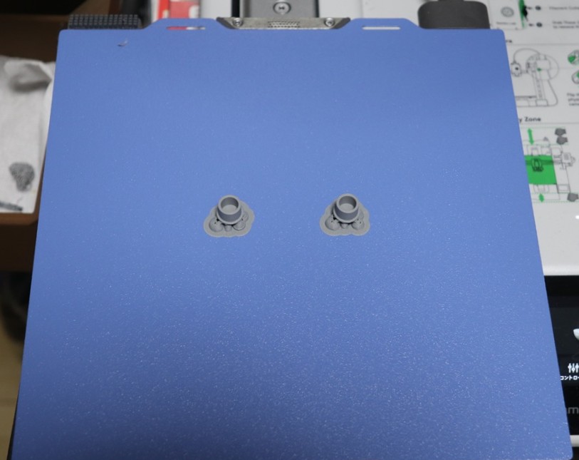 Small PLA parts firmly adhered to a Bambu Lab Cool Plate during printing